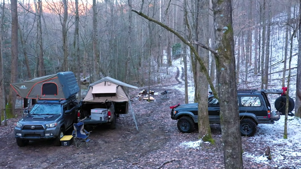 winter cars in forest with tents