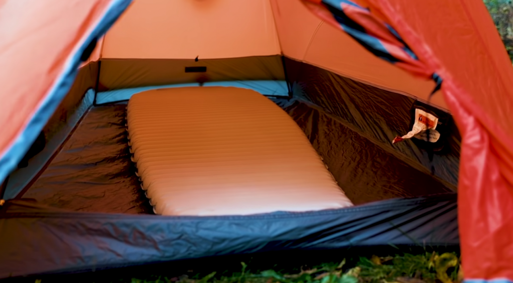 interior orange tent with inflatable matress for night in the winter
