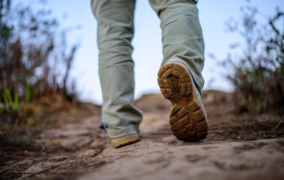 Closeup feet hiker man wearing boots walking